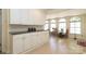 Extended kitchen space boasting ample white cabinets, great natural light, and dining area at 17333 Saranita Ln, Charlotte, NC 28278