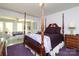 Serene main bedroom featuring a four-poster bed, sitting area, and ample natural light at 17333 Saranita Ln, Charlotte, NC 28278