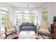 Bright sunroom with seating, arched windows and natural light at 17333 Saranita Ln, Charlotte, NC 28278