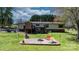 Expansive backyard with deck, stone fire pit, and mature landscaping, perfect for outdoor living at 2003 Cape Hickory Cutoff Rd, Hickory, NC 28601