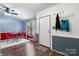 Retro dining area with a red table and chairs, unique wall decor, and wood flooring at 2003 Cape Hickory Cutoff Rd, Hickory, NC 28601