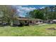 Spacious home exterior featuring a well-maintained lawn and a fenced yard at 2003 Cape Hickory Cutoff Rd, Hickory, NC 28601