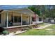 Inviting front porch with seating area, showcasing a well-kept lawn and garden at 2003 Cape Hickory Cutoff Rd, Hickory, NC 28601
