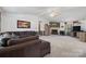 Comfortable living room featuring a stone fireplace, plush sofa, and neutral decor at 2003 Cape Hickory Cutoff Rd, Hickory, NC 28601