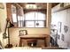 Bedroom featuring an industrial style with exposed brick, an arched window, and a wood desk at 201 S Hoskins Rd # 132, Charlotte, NC 28208