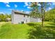 View of backyard with green lawn and gray siding on the house, showcasing outdoor space at 2115 Sonoma Valley Dr, Charlotte, NC 28214