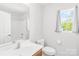 Clean, bright bathroom featuring a sink, toilet, mirror, and a walk-in shower with white tile at 2115 Sonoma Valley Dr, Charlotte, NC 28214