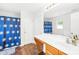 Bathroom with a sink, vanity, mirror, and a shower featuring a blue patterned curtain for privacy at 2115 Sonoma Valley Dr, Charlotte, NC 28214