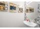 Powder room features a sink, decorative mirror, and statement artwork for a modern aesthetic at 2115 Sonoma Valley Dr, Charlotte, NC 28214