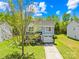 Charming two-story home with gray siding, a black roof, and manicured landscaping on a beautiful sunny day at 2115 Sonoma Valley Dr, Charlotte, NC 28214