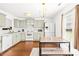 Well lit kitchen featuring stainless steel appliances, light green cabinets and dining table with bench seating at 2115 Sonoma Valley Dr, Charlotte, NC 28214