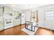 Bright, eat-in kitchen featuring white appliances, ample cabinet space, and a casual dining area with modern lighting at 2115 Sonoma Valley Dr, Charlotte, NC 28214