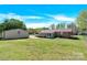 Large backyard with a detached metal garage and a brick house at 2116 1St Avenue Nw Pl, Hickory, NC 28601