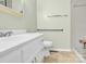 Bright bathroom with tile shower, hand rails, and a white sink vanity at 2116 1St Avenue Nw Pl, Hickory, NC 28601