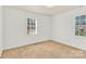 Well-lit bedroom with neutral carpet and two windows offering natural light at 2116 1St Avenue Nw Pl, Hickory, NC 28601