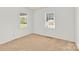 Bright bedroom features neutral carpet and large windows with views of the outdoors at 2116 1St Avenue Nw Pl, Hickory, NC 28601