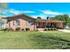 Charming brick home with a well-maintained lawn, mature landscaping, and an inviting covered front porch at 2116 1St Avenue Nw Pl, Hickory, NC 28601