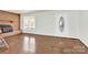 Bright living room with hardwood floors, a brick fireplace, and a large window for ample natural light at 2116 1St Avenue Nw Pl, Hickory, NC 28601