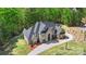 Beautiful aerial view of an estate featuring a circular driveway and lush landscaping at 220 Palm Cove Way, York, SC 29745