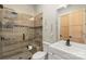 This gorgeous bathroom features a glass enclosed tile shower and white vanity at 220 Palm Cove Way, York, SC 29745