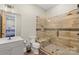 This gorgeous bathroom features a glass enclosed tile shower and white vanity at 220 Palm Cove Way, York, SC 29745