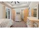 This bedroom has neutral walls and carpet, ceiling fan, and access to the ensuite bathroom at 220 Palm Cove Way, York, SC 29745