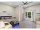 This stylish bedroom features carpeted floors, a ceiling fan, and great natural light at 220 Palm Cove Way, York, SC 29745