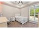 This bedroom has neutral walls and carpet, ceiling fan, and great natural light at 220 Palm Cove Way, York, SC 29745