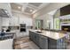 Modern kitchen featuring stainless steel appliances, a large island, and seamless flow into the living area at 220 Palm Cove Way, York, SC 29745