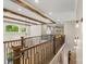 Spacious upper level featuring wood beam decor, railing, and view into a sitting area at 220 Palm Cove Way, York, SC 29745