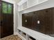 Functional mudroom area with built-in storage cubbies, bench seating, and coat hooks near entrance at 220 Palm Cove Way, York, SC 29745