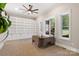 Bright office featuring built-in shelves, modern desk, tan carpet, and natural light from large windows at 220 Palm Cove Way, York, SC 29745