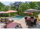 This backyard features a sparkling pool, hot tub and an outdoor dining area perfect for entertaining at 220 Palm Cove Way, York, SC 29745