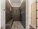 Modern shower with a built-in bench and mosaic tiled floor at 220 Palm Cove Way, York, SC 29745