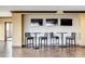 Modern bar area with high-top tables, chairs, and multiple flat-screen TVs for entertainment at 222 S Caldwell St # 1801, Charlotte, NC 28202