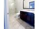 Modern bathroom with glass enclosed shower and granite vanity at 222 S Caldwell St # 1801, Charlotte, NC 28202
