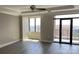 This bedroom features hardwood floors, large windows with skyline views, and a door leading to a private balcony at 222 S Caldwell St # 1801, Charlotte, NC 28202