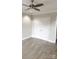 Neutral bedroom with wood floors, ceiling fan and closet at 222 S Caldwell St # 1801, Charlotte, NC 28202