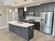 Modern kitchen featuring stainless steel appliances, island with white countertops and dark wood cabinets at 222 S Caldwell St # 1801, Charlotte, NC 28202