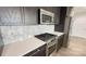 Close up view of the modern kitchen's stainless steel stove and white backsplash at 222 S Caldwell St # 1801, Charlotte, NC 28202