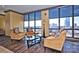 Comfortable living room with city views through large windows, furnished with stylish seating at 222 S Caldwell St # 1801, Charlotte, NC 28202