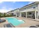 Inviting backyard features a kidney-shaped pool, hot tub, and covered patio for relaxation and entertainment at 2262 Galloway Sw Ln, Concord, NC 28025