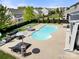 Aerial view of a beautiful backyard oasis featuring a uniquely shaped pool, lounge seating, and manicured lawn at 2262 Galloway Sw Ln, Concord, NC 28025