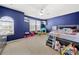 Cozy bedroom featuring a large window, blue accent wall, and a variety of toys at 2262 Galloway Sw Ln, Concord, NC 28025