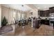 Open dining area with a large table, statement lighting, and an adjacent modern kitchen at 2262 Galloway Sw Ln, Concord, NC 28025