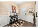 Inviting foyer with wood flooring, decorative console table, wainscoting and neutral paint at 2262 Galloway Sw Ln, Concord, NC 28025