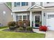 Inviting front entrance featuring a manicured lawn, dark shutters, and a well-maintained exterior at 2262 Galloway Sw Ln, Concord, NC 28025