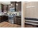 Modern kitchen offers stainless steel appliances and a built-in bench with hooks for added functionality at 2262 Galloway Sw Ln, Concord, NC 28025