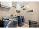 Well-lit laundry room with front-load washer/dryer, cabinets, and decorative 'Live Love Laugh' wall art at 2262 Galloway Sw Ln, Concord, NC 28025