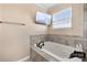 This elegant primary bathroom features a soaking tub with tile surround and tv at 2262 Galloway Sw Ln, Concord, NC 28025